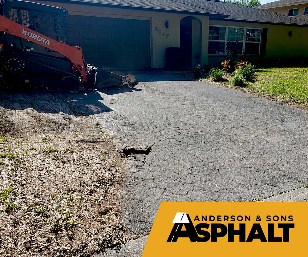 Construction removing old pavement from driveway