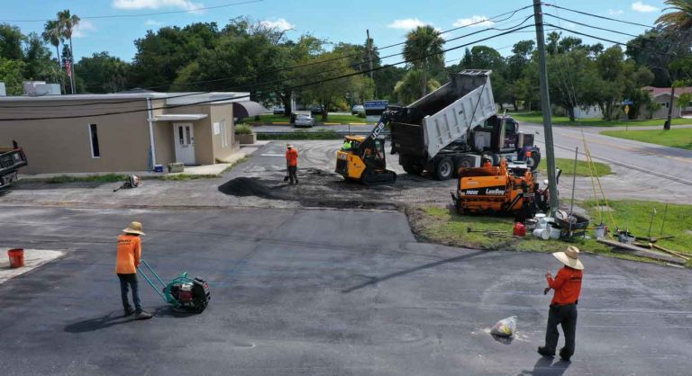 Commercial asphalt team working on asphalt parking lot