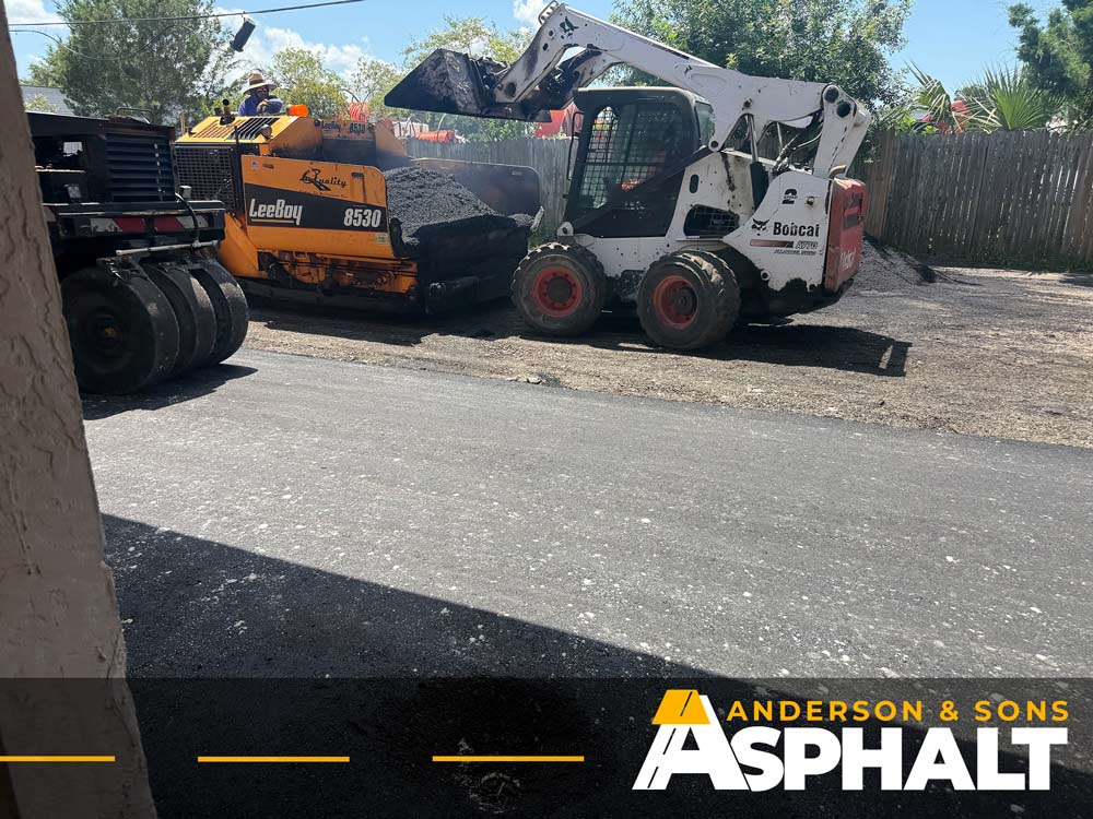 Asphalt paving equipment installing new surface during commercial resurfacing project