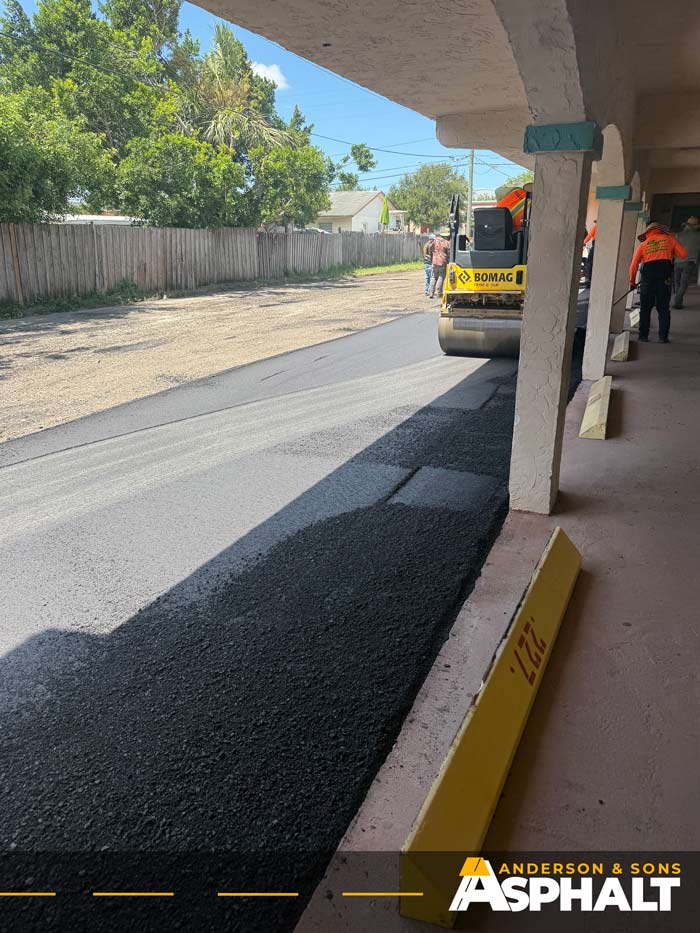 Asphalt roller compacting freshly paved parking lot in Clearwater FL
