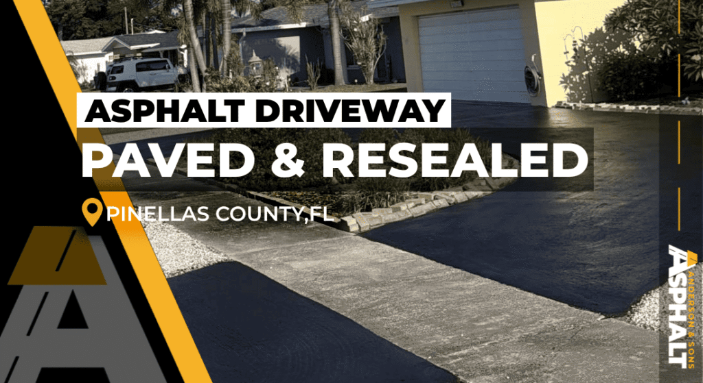 Newly resealed circular asphalt driveway in front of a yellow home