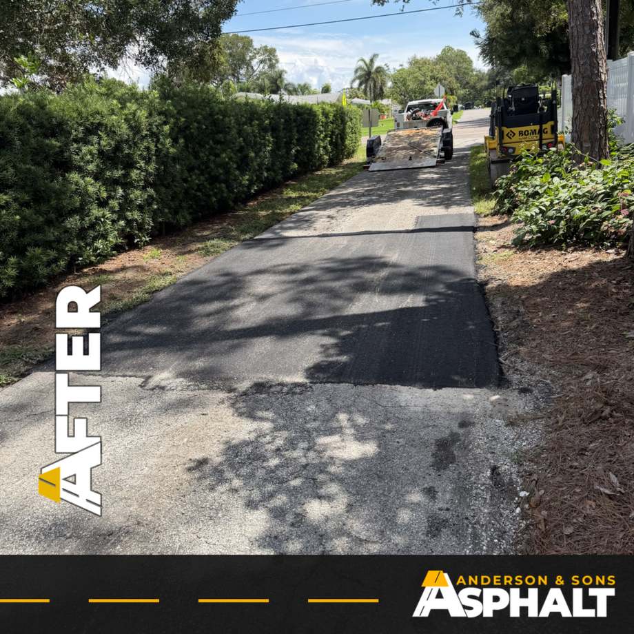 New asphalt section running down a condo drive lane with the crew beyond